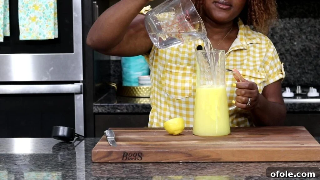Tropical Zest Quench 7 Adding water into a pitcher