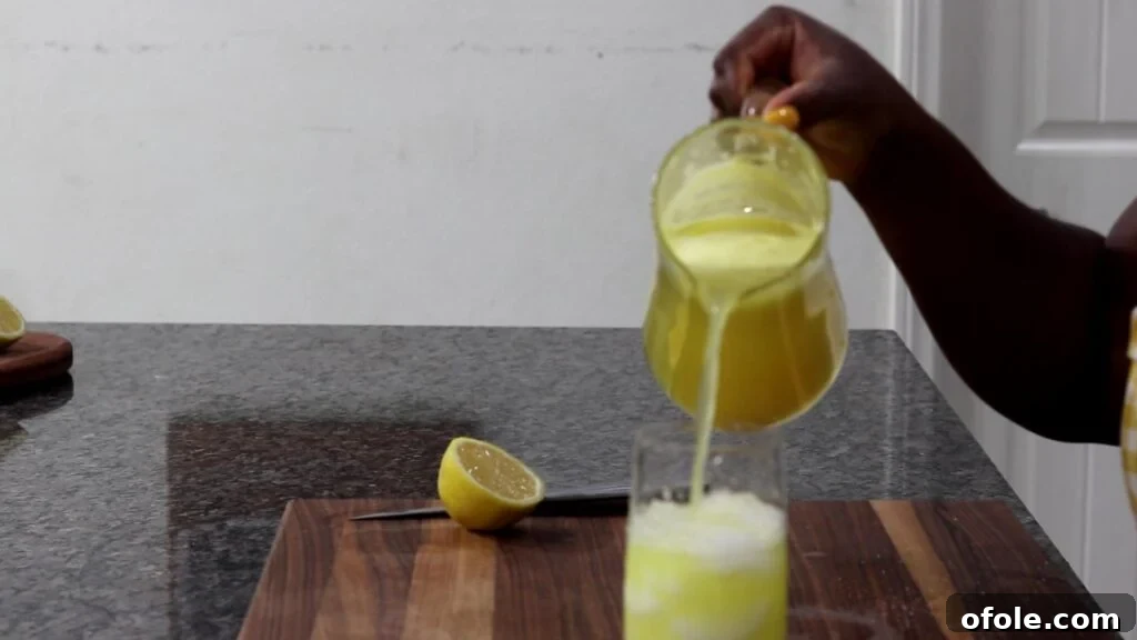 Tropical Zest Quench 8 Pouring drink over ice