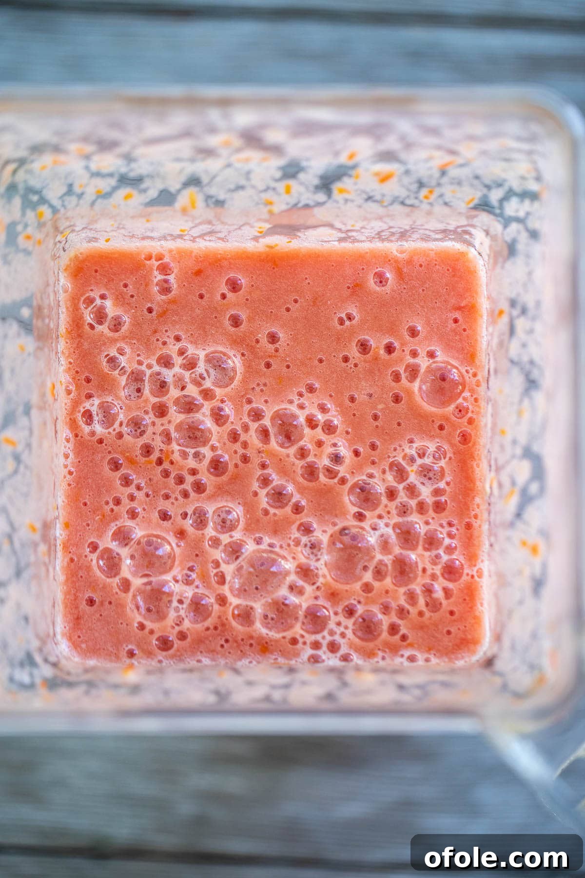 Slow-Simmered Homemade Tomato Paste 6 Smooth tomato puree being blended in a high-speed blender.