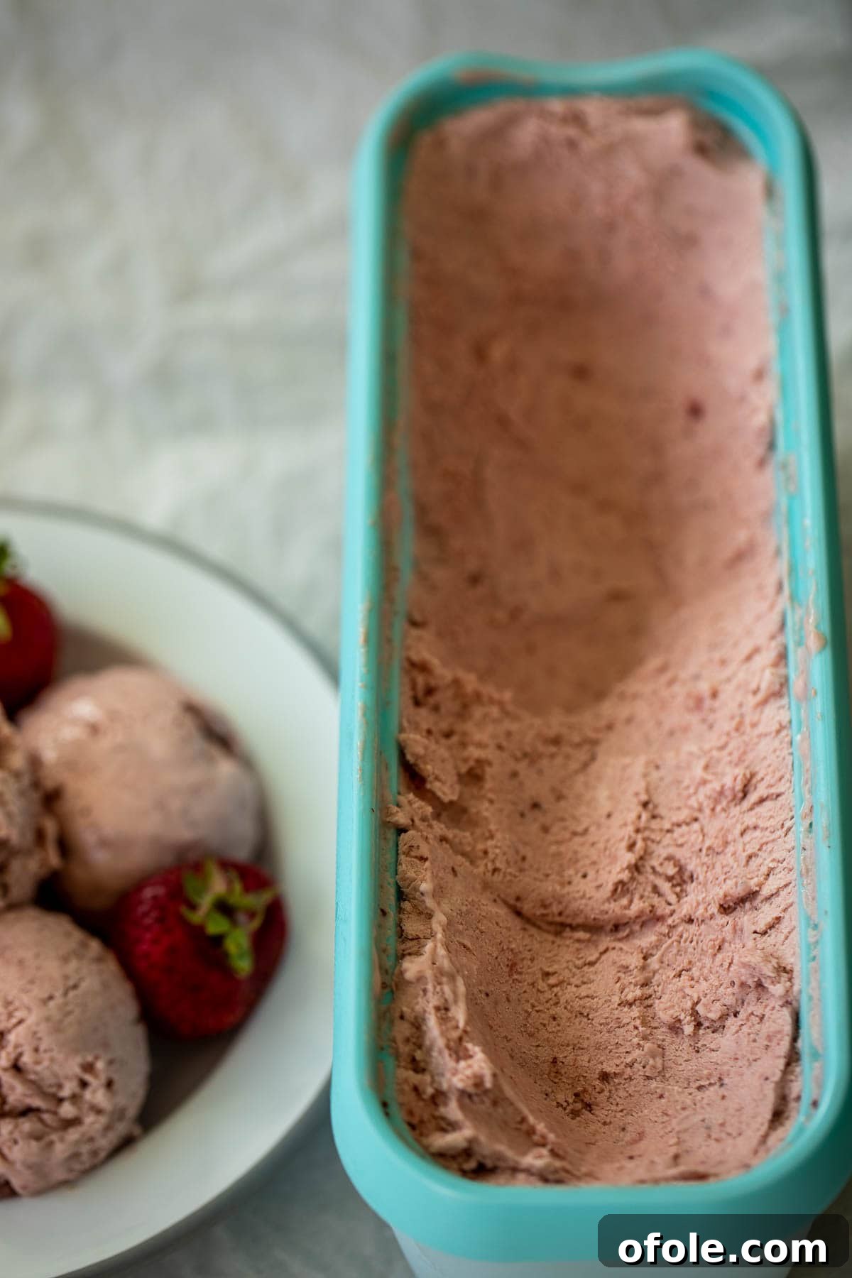 Easy No Churn Strawberry Ice Cream 3 Close-up of a bowl filled with creamy strawberry ice cream, showing its smooth texture