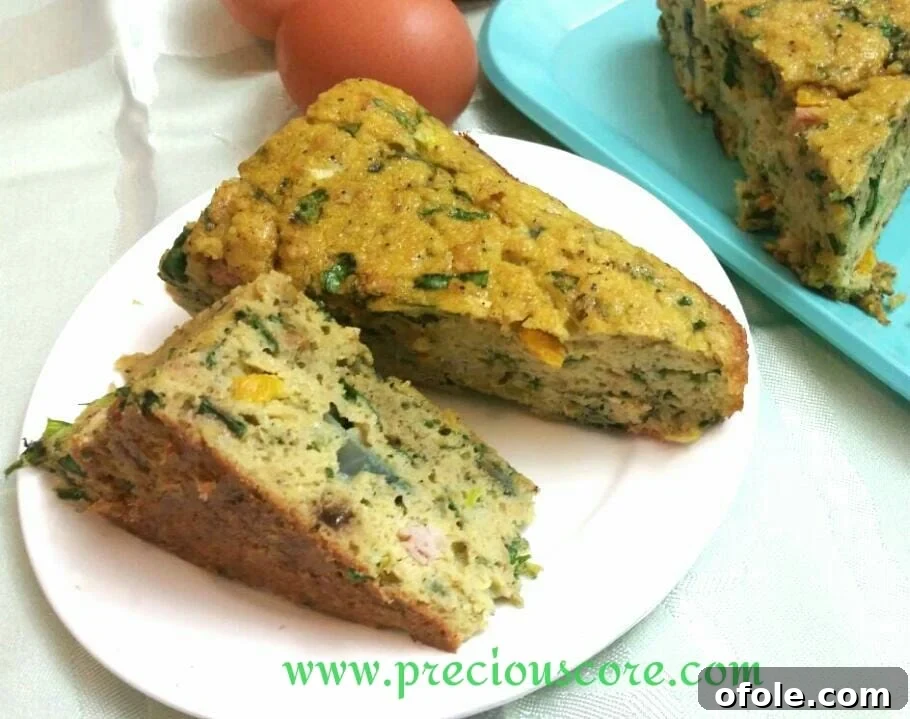 Unlock the Secret to Perfect Egg Cake 4 A close-up shot of a slice of egg cake with visible vegetables and herbs