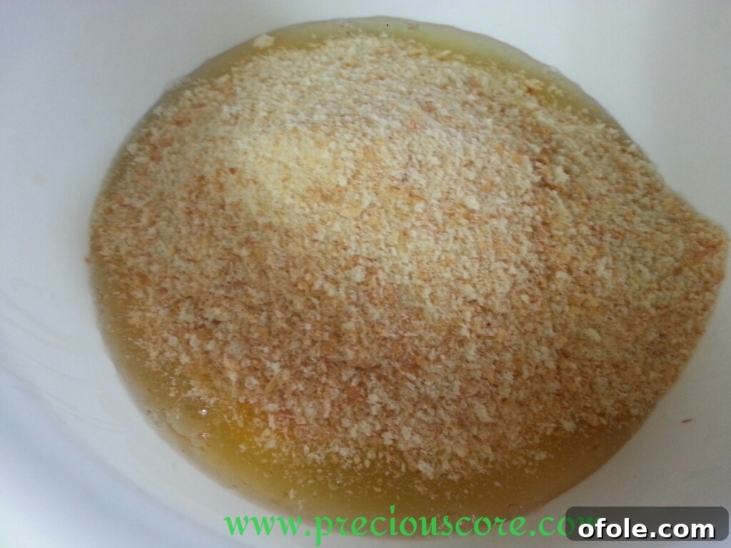 Unlock the Secret to Perfect Egg Cake 6 Breadcrumbs being added to the bowl with cracked eggs