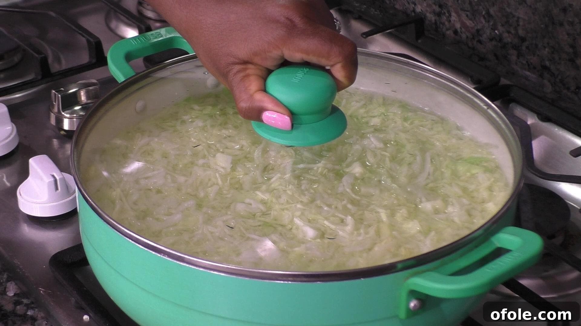 Shredded cabbage submerged in a large pot of boiling water, ready for blanching.