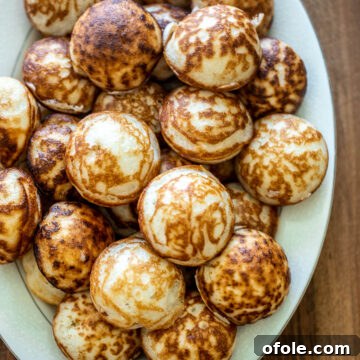 Tray of Vitumbua, perfectly round and golden-brown.