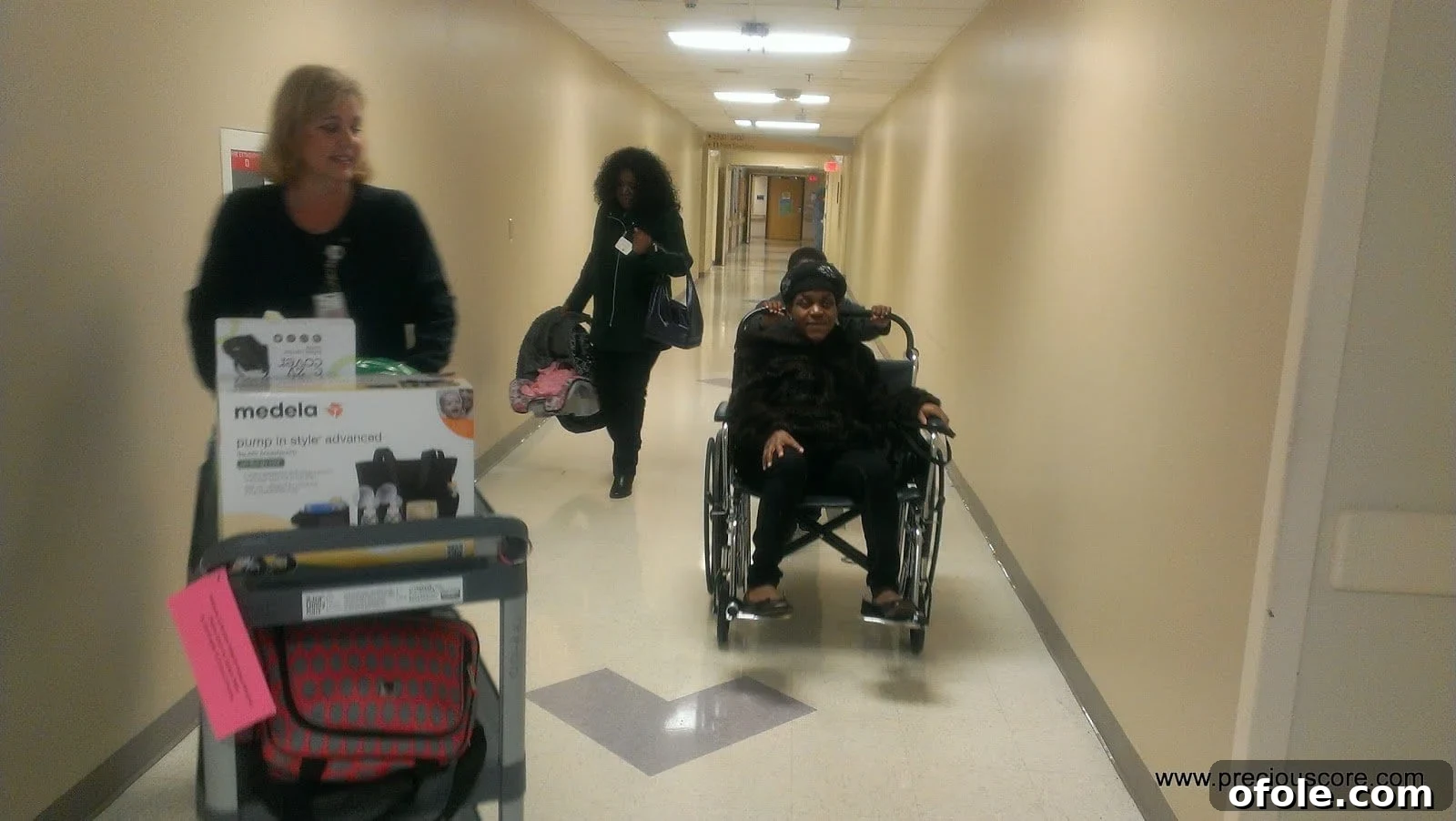 My Third American Birth Story 8 Mother in wheelchair leaving hospital with baby