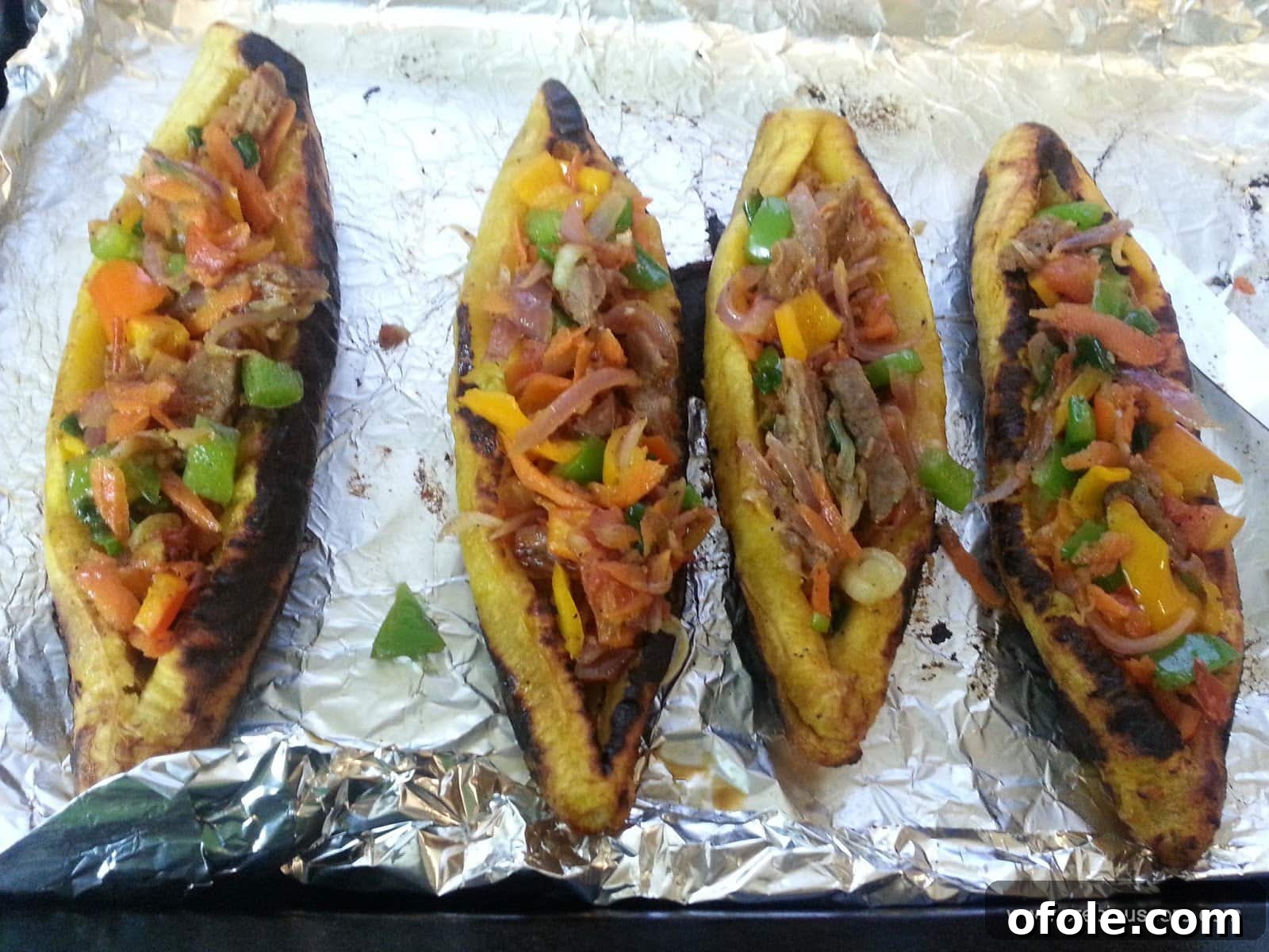 Plantain Boats: Unlock Your Creativity with Tropical Flavors 15 Multiple plantain boats stuffed with filling, arranged on a baking tray