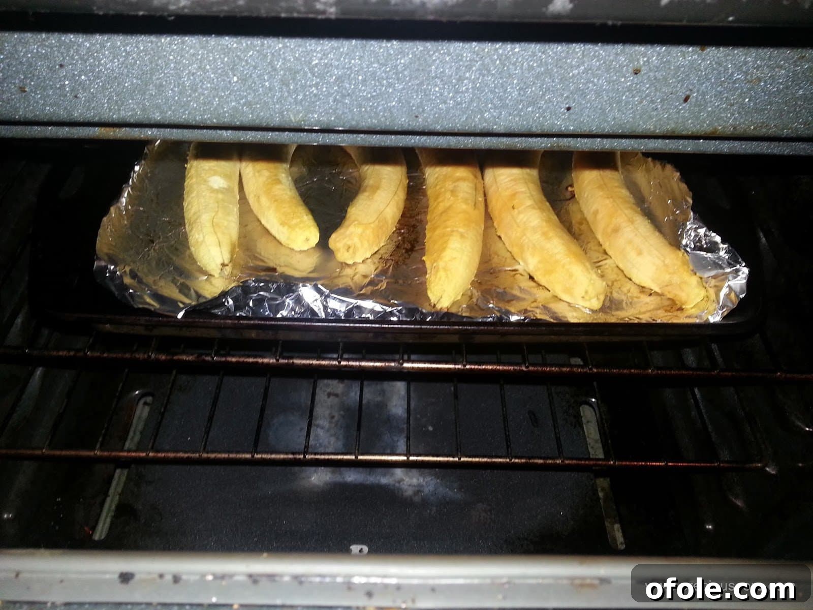Plantain Boats: Unlock Your Creativity with Tropical Flavors 4 Peeled ripe plantains placed on a greased baking tray, ready for roasting