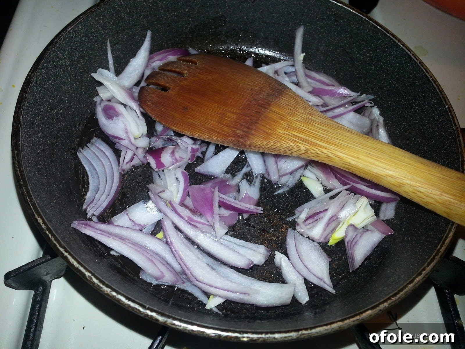 Plantain Boats: Unlock Your Creativity with Tropical Flavors 6 Chopped onions sautéing in olive oil in a pan