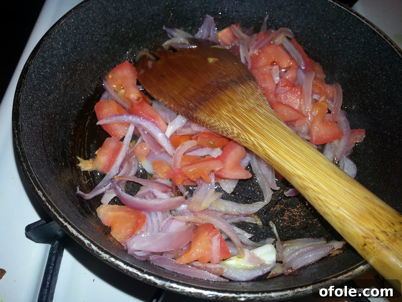 Plantain Boats: Unlock Your Creativity with Tropical Flavors 7 Chopped tomatoes added to sautéed onions in the pan