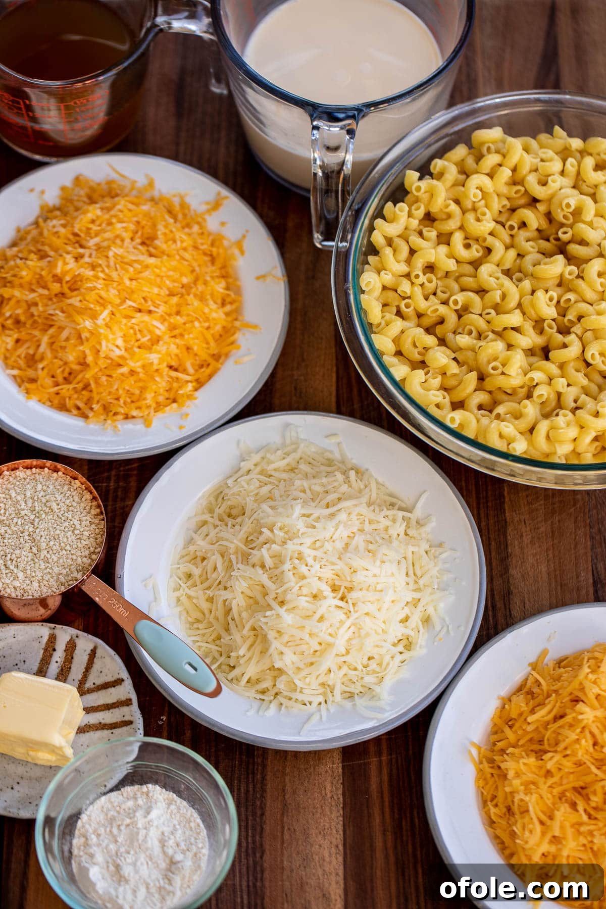 Ultimate Three-Cheese Mac and Cheese 3 Ingredients for 3 cheese mac and cheese laid out on a chopping board