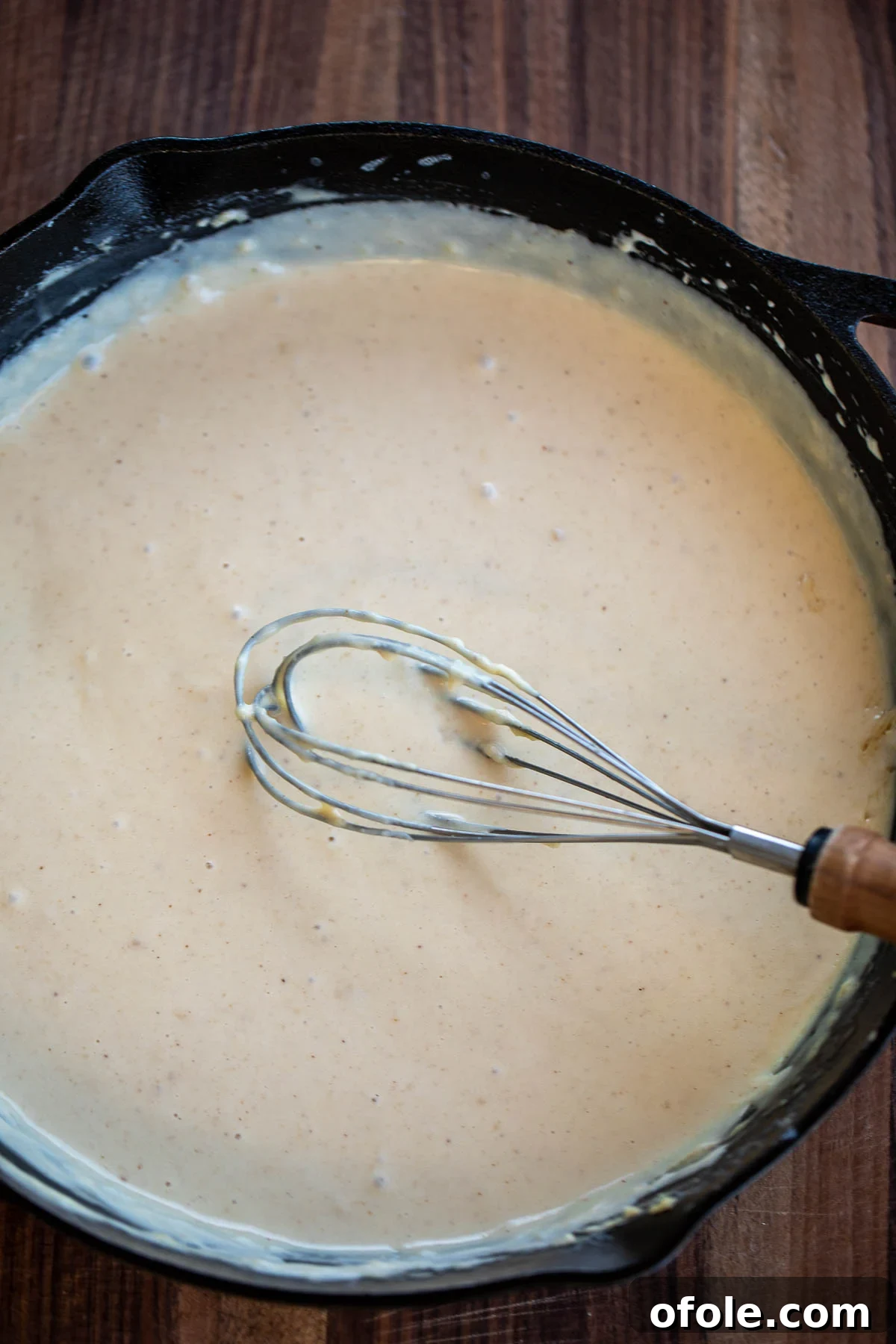 Ultimate Three-Cheese Mac and Cheese 5 Skillet of bubbling cheese sauce being prepared
