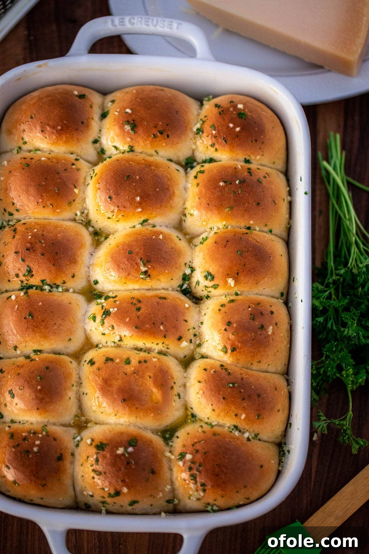 Buttery Garlic Dinner Rolls 2 A full baking dish of golden brown dinner rolls brushed with glistening garlic butter, ready to serve.