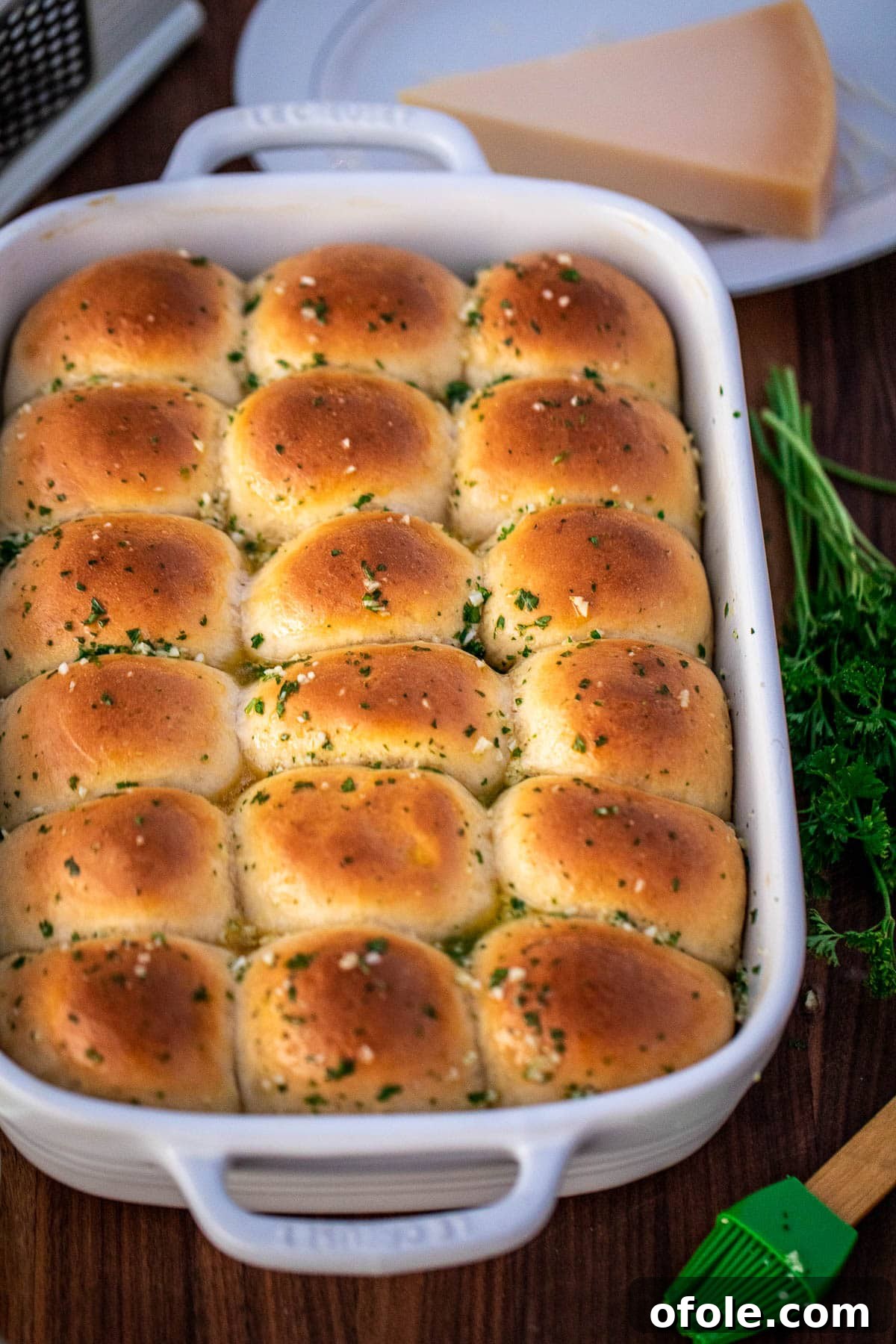 Buttery Garlic Dinner Rolls 13 A complete baking dish of golden garlic dinner rolls, glistening with butter and ready to be enjoyed.