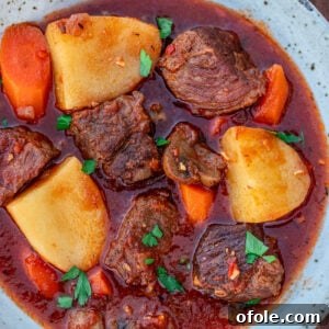 Square picture for hearty beef stew without wine, garnished with fresh herbs.