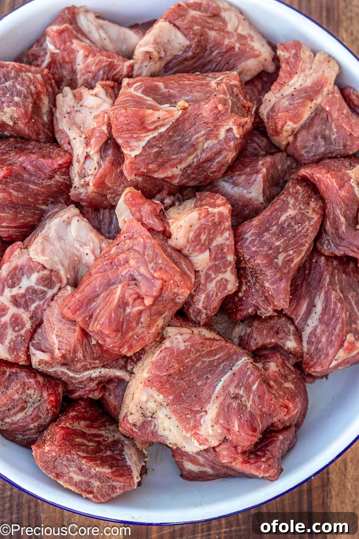 Wine-Free Beef Stew 6 Generously seasoned beef chunks in a white bowl, ready for browning.