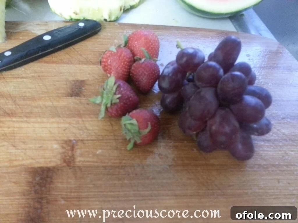 Vibrant Cameroonian Fruit Salad 12 An array of additional colorful fruits like kiwi, grapes, and berries, suitable for a varied fruit salad