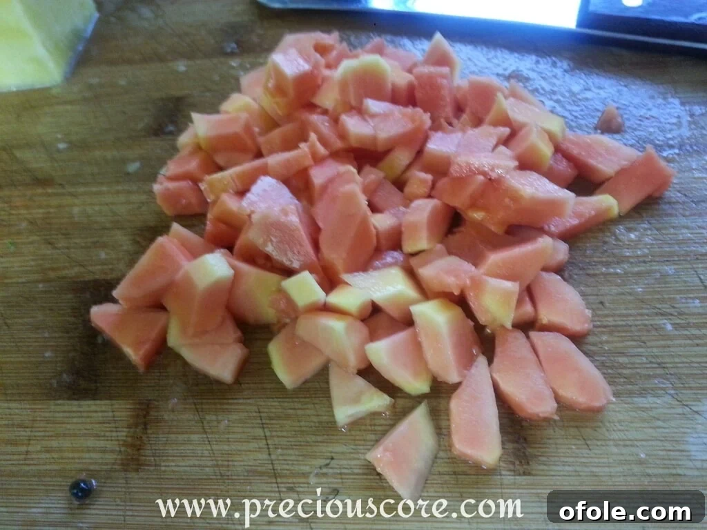 Vibrant Cameroonian Fruit Salad 5 Diced pawpaw (papaya) pieces, ready to be added to the fruit salad