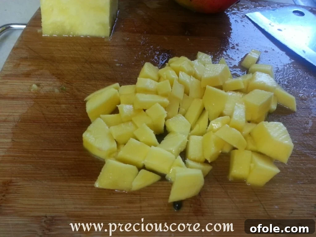 Vibrant Cameroonian Fruit Salad 7 Diced mango pieces, bright orange and ready for the fruit salad
