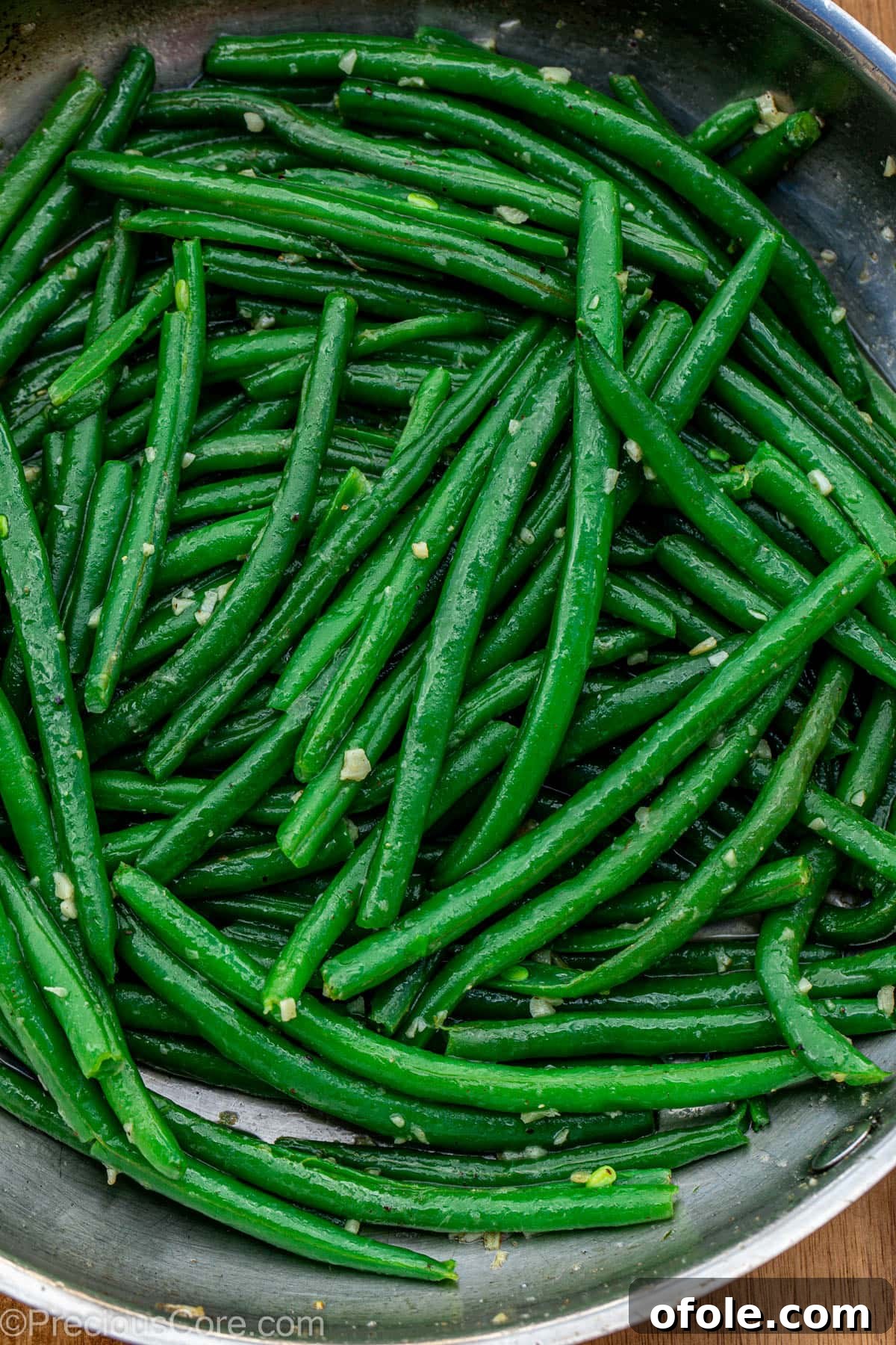 Skillet of garlic butter green beans, ready to serve.