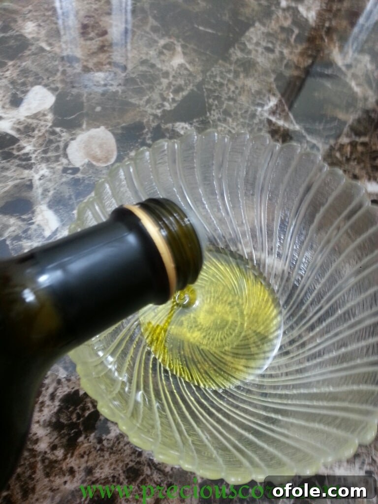 Olive oil poured into a mixing bowl