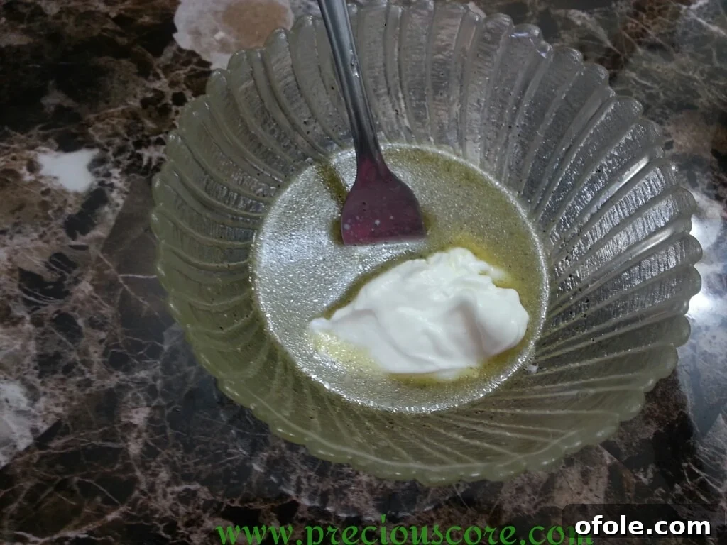Greek yogurt being added to the dressing mixture