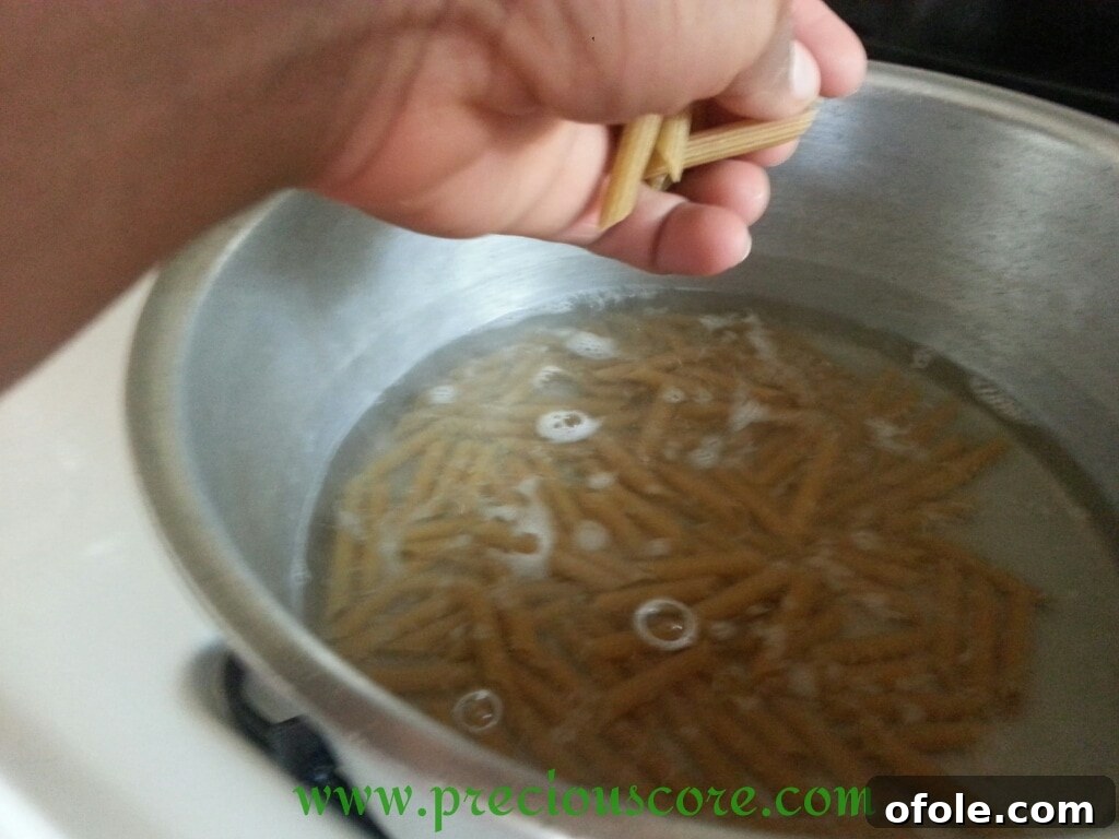 Whole wheat macaroni cooking in boiling water