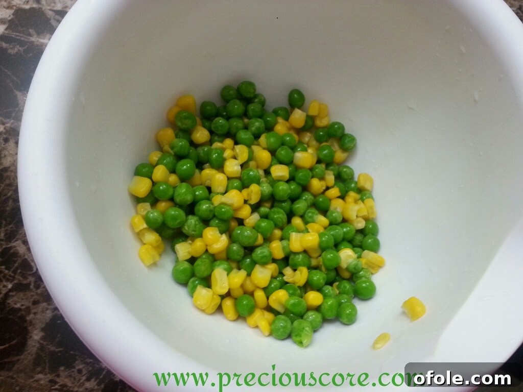 Rinsed sweet corn and peas in a bowl