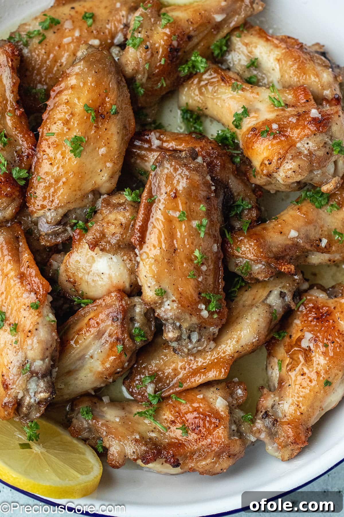 Garlic Gold Wings 2 Garlic Butter Wings elegantly arranged in a white serving dish, ready to be enjoyed.