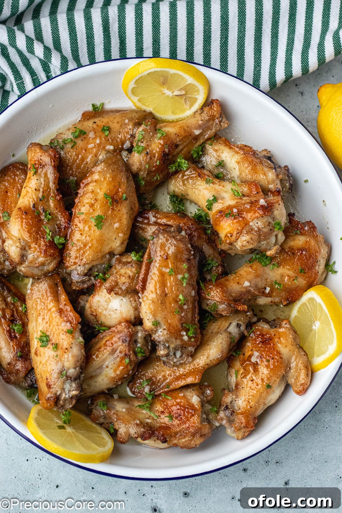Garlic Gold Wings 11 Cooked chicken wings beautifully garnished with vibrant minced parsley, adding freshness and color.