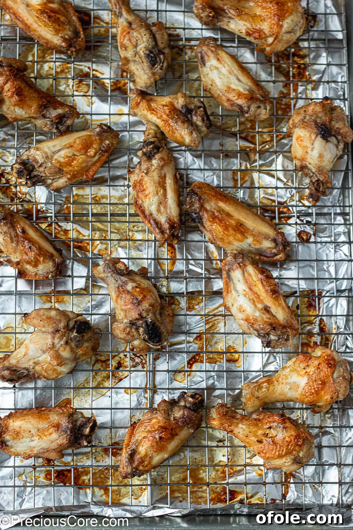 Garlic Gold Wings 7 Crispy, golden-brown baked chicken wings displayed on a baking rack, fresh out of the oven.