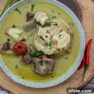 Authentic Cameroonian Pepper Soup 6 Bowl of pepper soup sitting on a round platter.