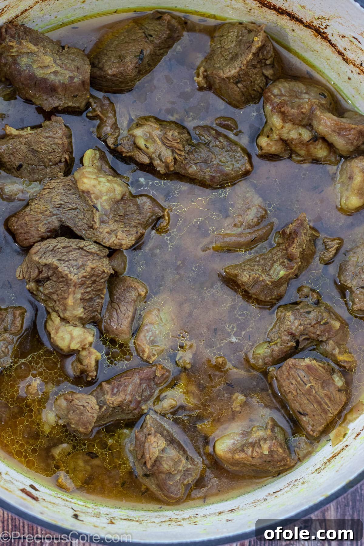 Soulful Nigerian Beef Stew 5 Cooked beef in its rich stock, showing tenderness and flavor infusion.