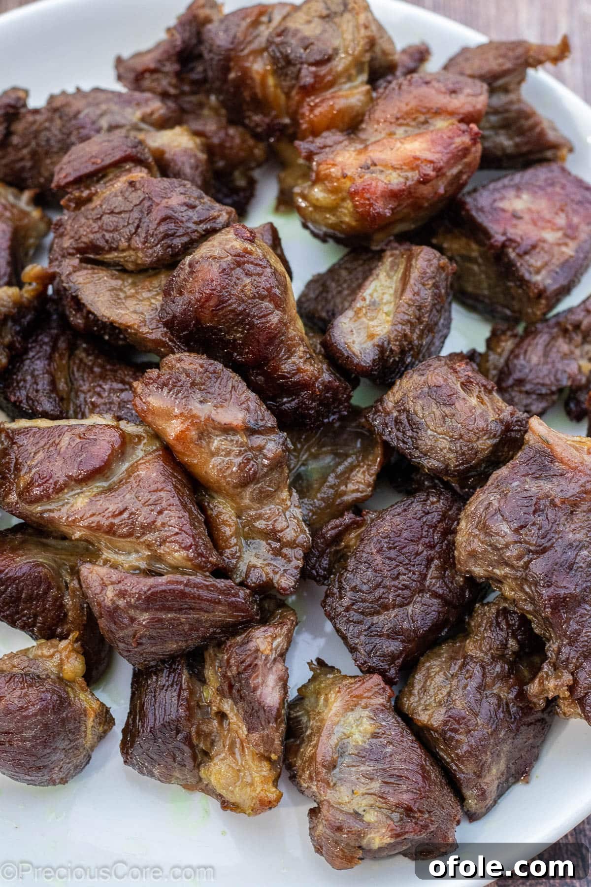 Soulful Nigerian Beef Stew 6 Beautifully fried beef pieces on a white plate, golden brown and ready for the stew.