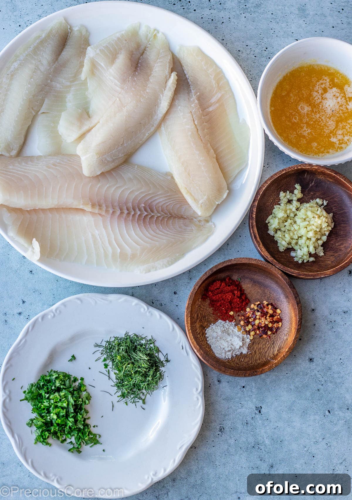 Garlic Butter Infused Tilapia 3 All the fresh ingredients for Garlic Butter Tilapia arranged on a rustic slab.