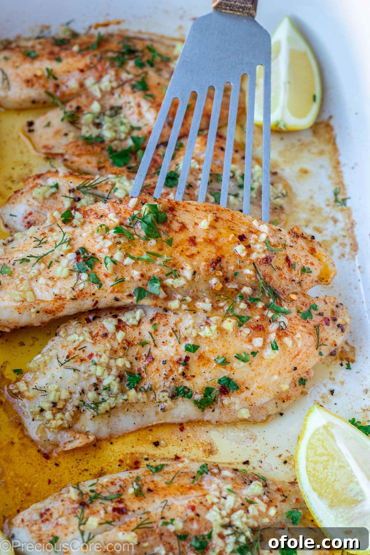 Garlic Butter Infused Tilapia 4 A single tilapia fillet perfectly seasoned with garlic butter, ready for baking.