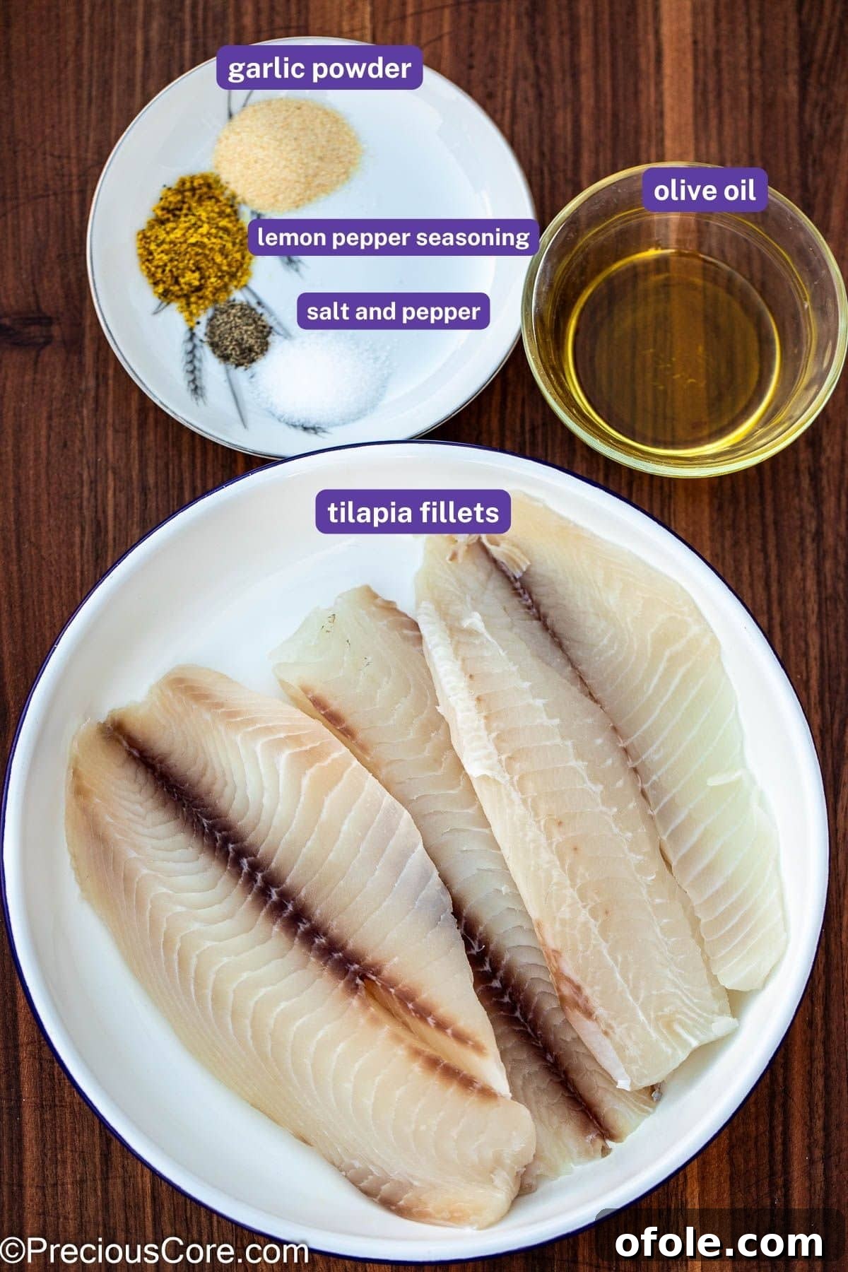 A flat lay photograph of all the ingredients needed for lemon pepper fish, neatly labeled.