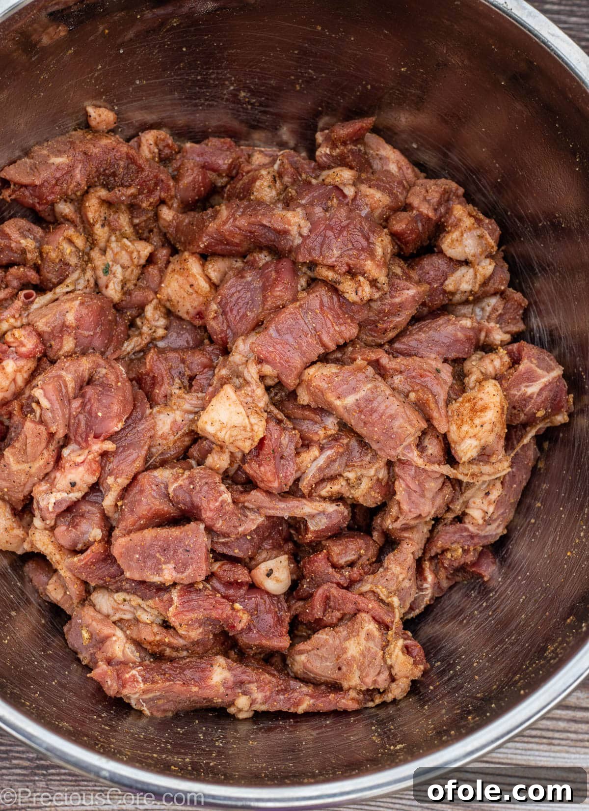Cameroonian Soya Snack 6 A stainless steel bowl showcasing perfectly seasoned bite-sized beef pieces, glistening with spices.
