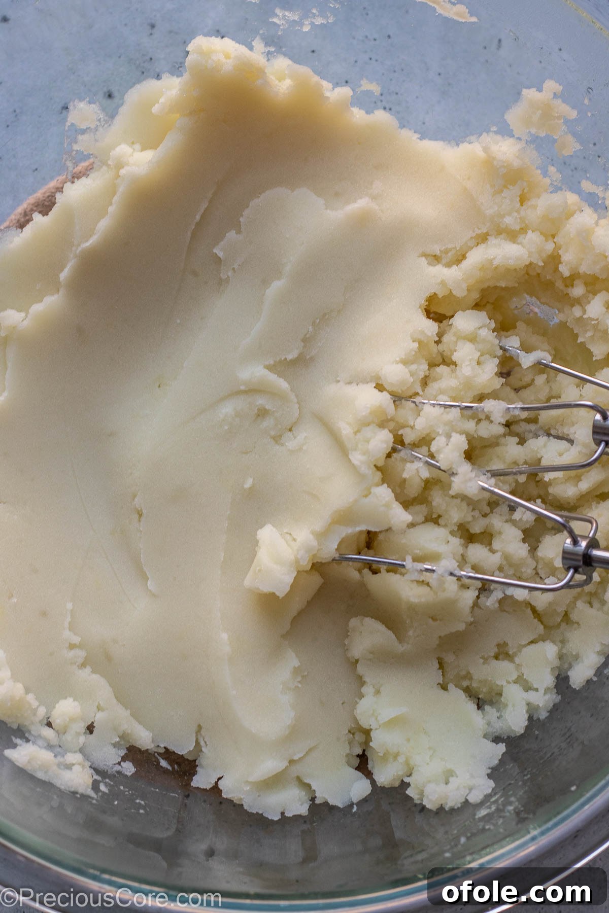 Aromatic Rosemary Garlic Mash 6 Hand beater in a bowl of mashed potatoes.