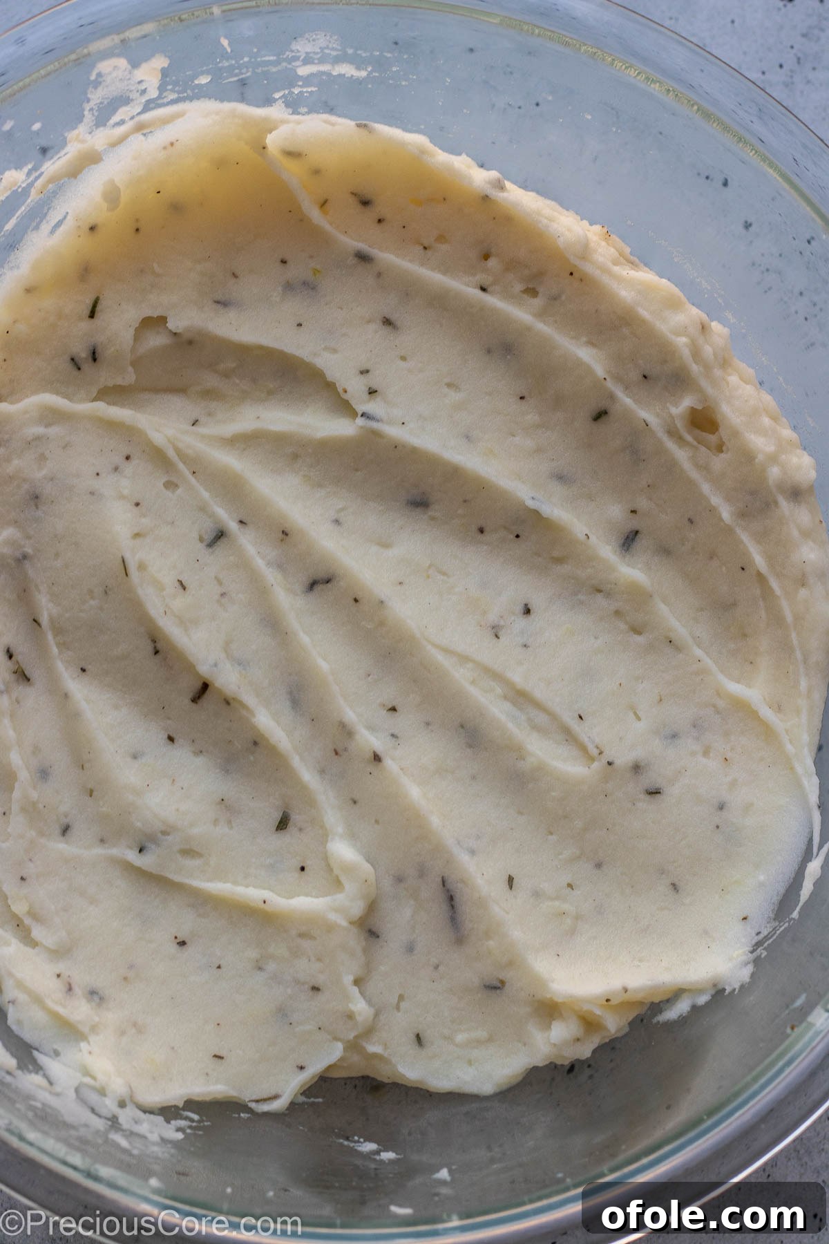 Aromatic Rosemary Garlic Mash 8 Rosemary garlic mashed potatoes in a large mixing bowl.