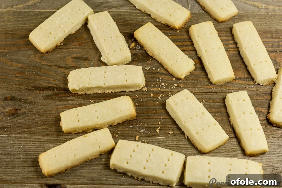 Perfect Buttery Shortbread From Scratch 15 Freshly baked shortbread cookies, golden brown at the edges, cooling on the baking sheet right out of the oven.