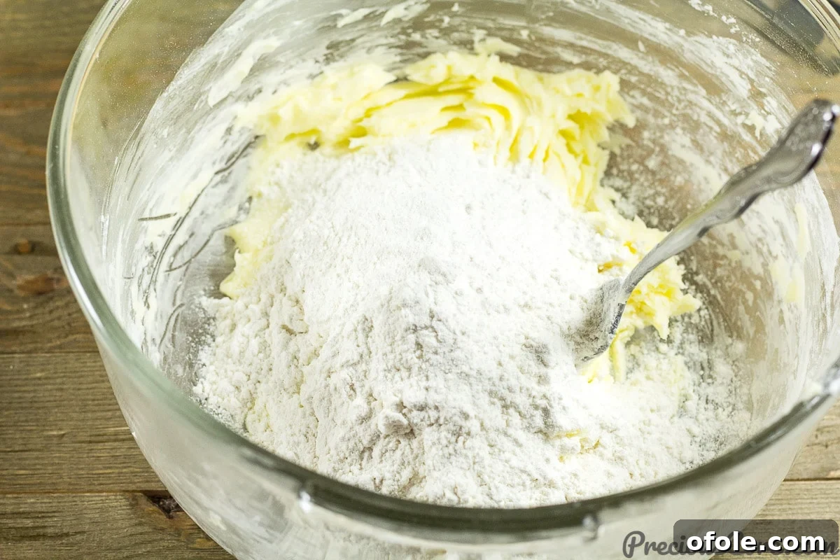 Perfect Buttery Shortbread From Scratch 8 Adding sifted flour to the creamed butter and sugar mixture for shortbread cookie dough.