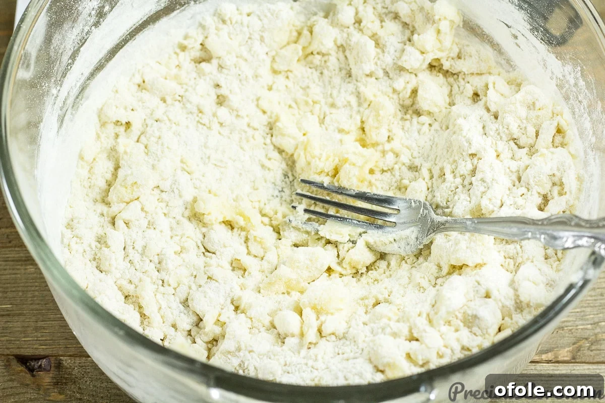 Perfect Buttery Shortbread From Scratch 9 Mixing shortbread cookie dough by hand, gathering the crumbly mixture into a soft, cohesive dough.