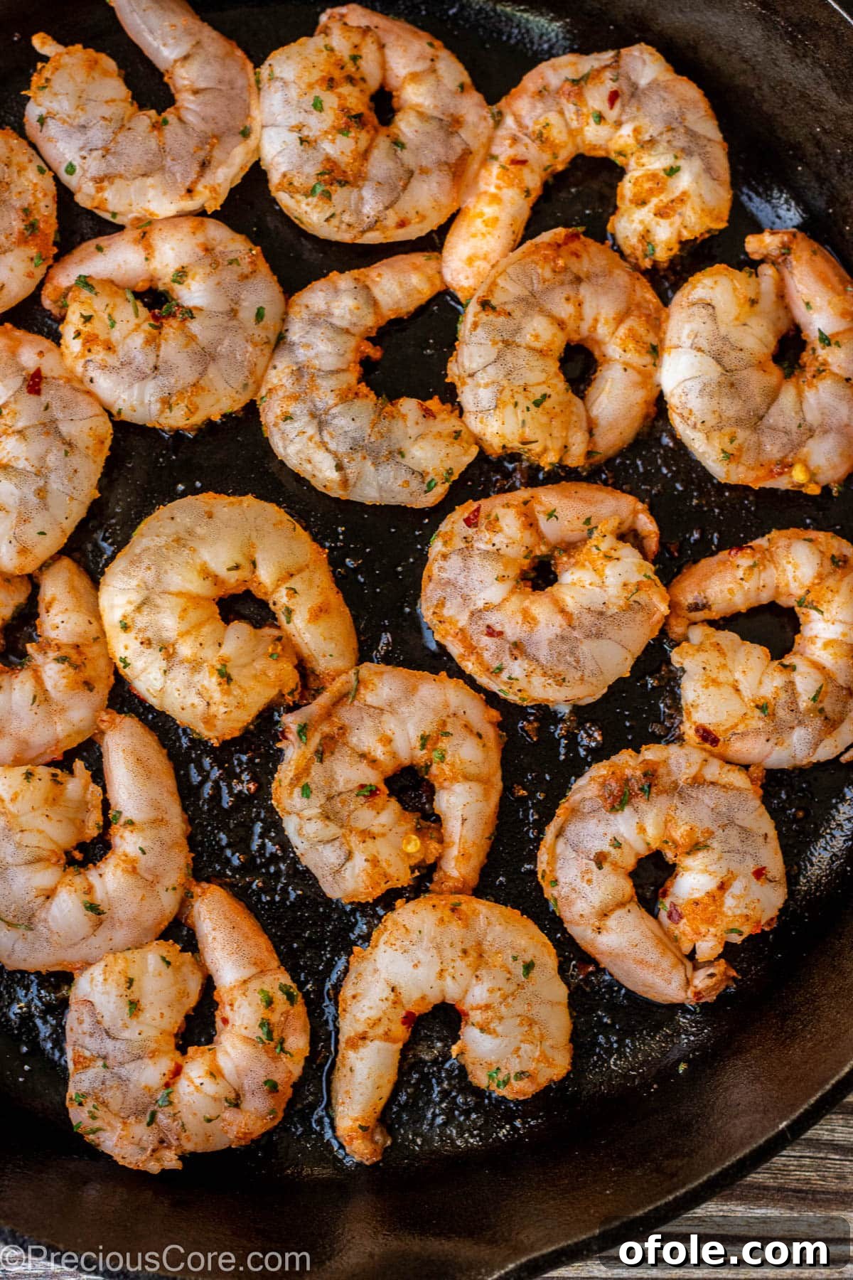 Sizzling Garlic Shrimp 5 Seasoned shrimp cooking in a 12-inch cast iron skillet, forming a delicious crust.