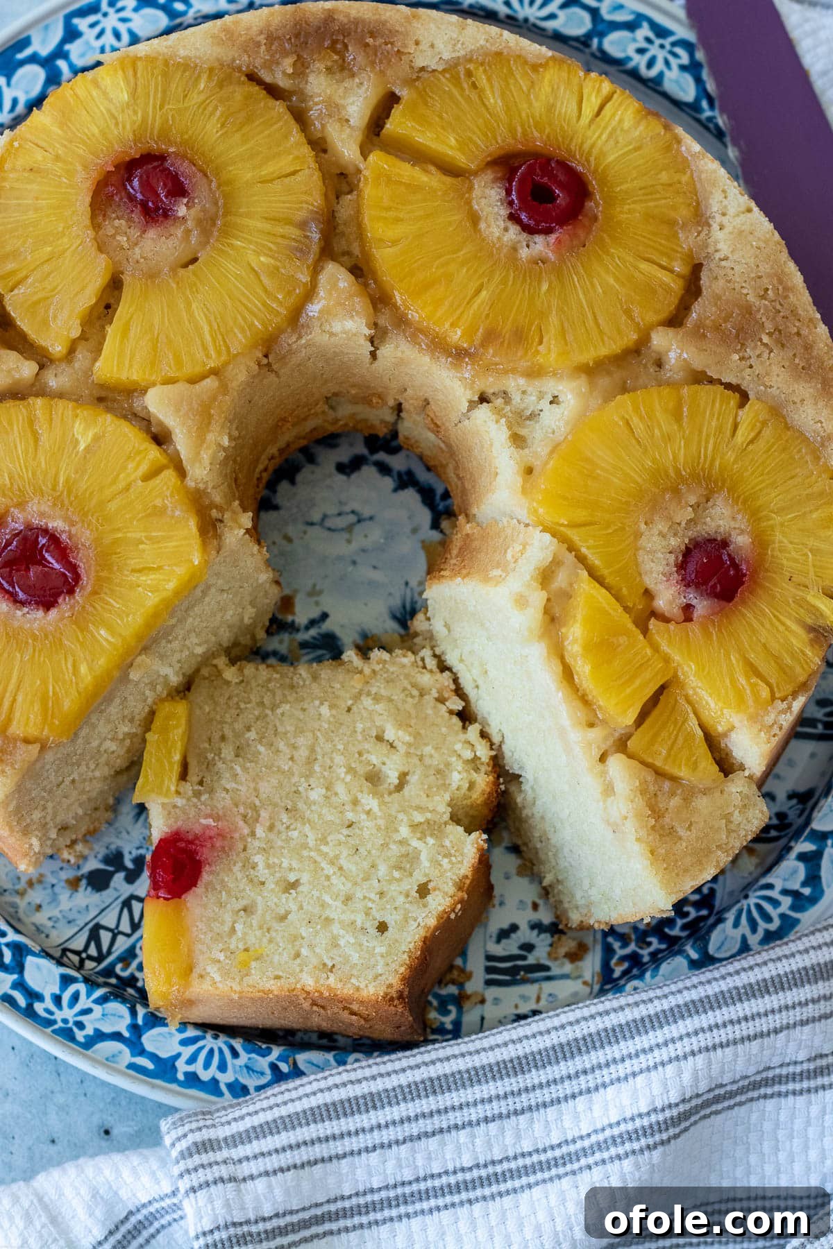 Pineapple Upside Down Pound Cake with pineapple slices and maraschino cherries on top, ready to be served.