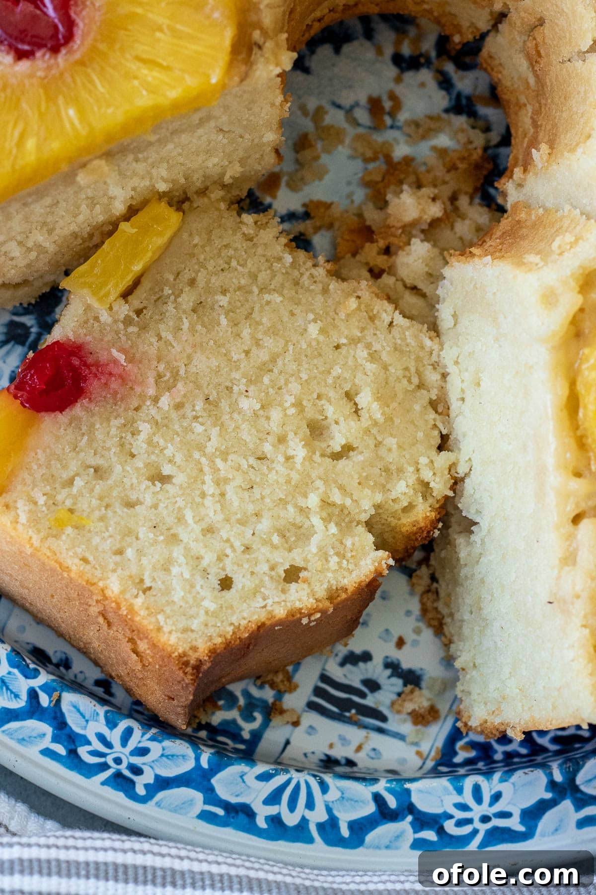 A delectable slice of Pineapple Upside Down Pound Cake served on an elegant blue tray.
