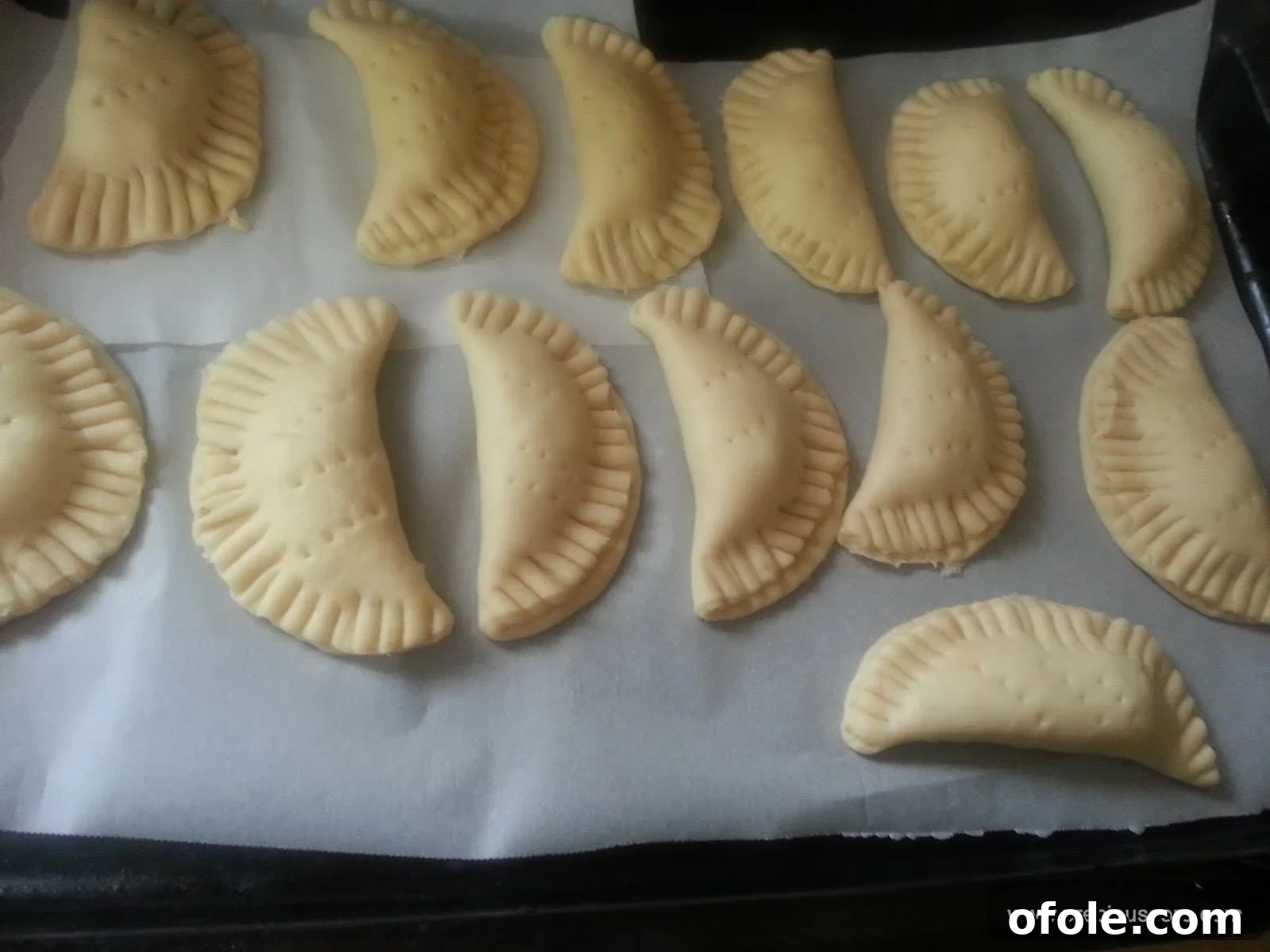 Assembled fish pies arranged on a baking tray