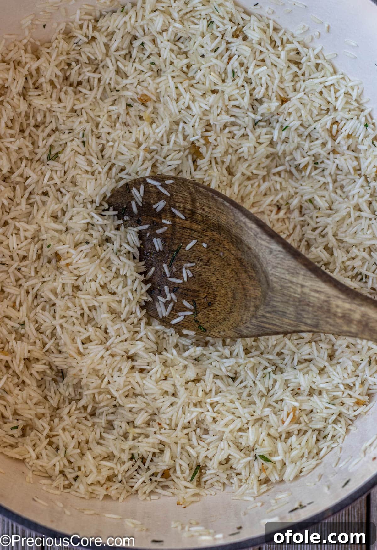 Toasted rice mixed with water and seasonings, including bouillon powder, salt, and pepper, ready for cooking in a pot.