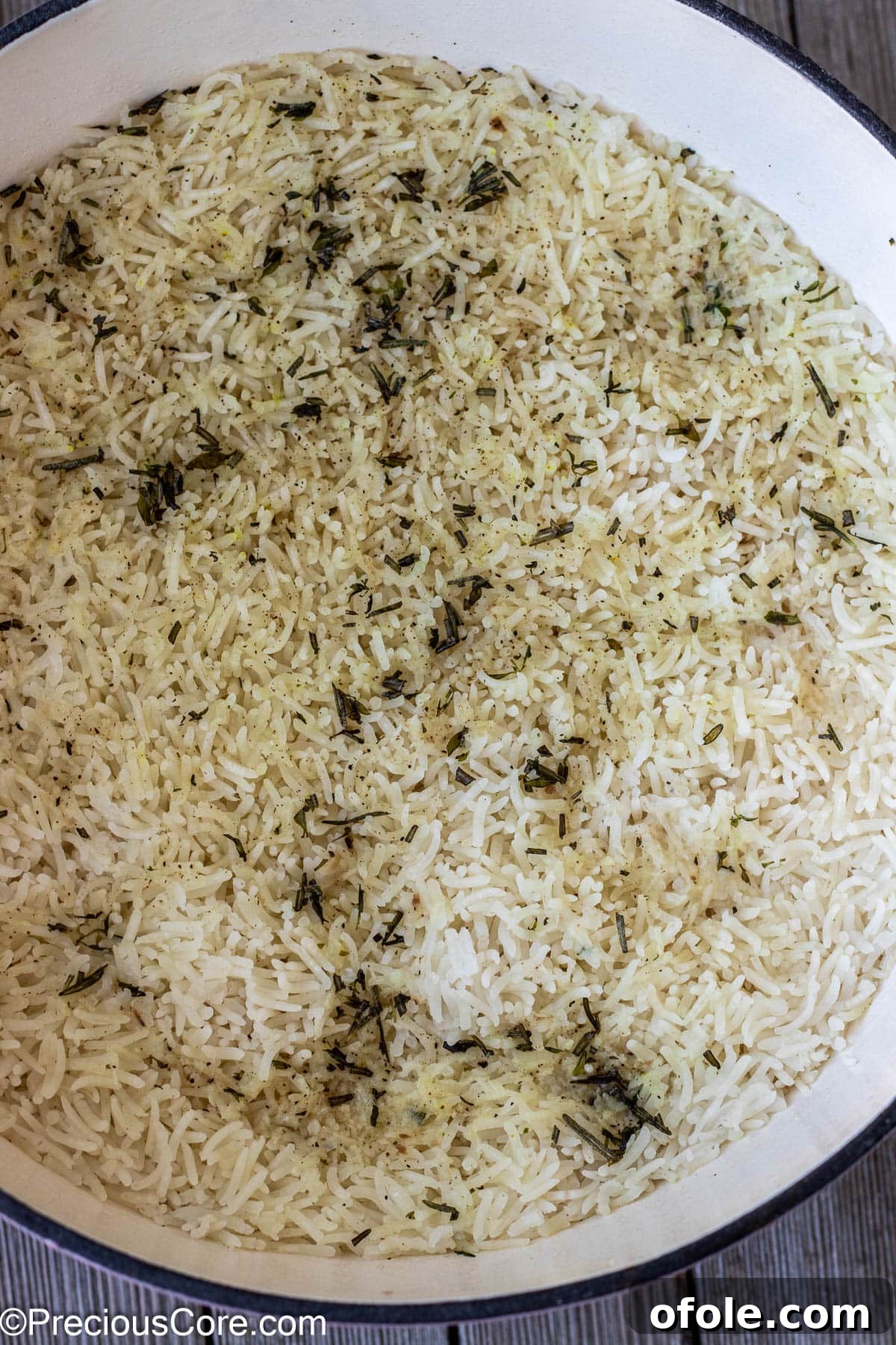 Perfectly cooked garlic and herb rice, steaming gently in a pot after resting, ready for the final touches of butter and parsley.