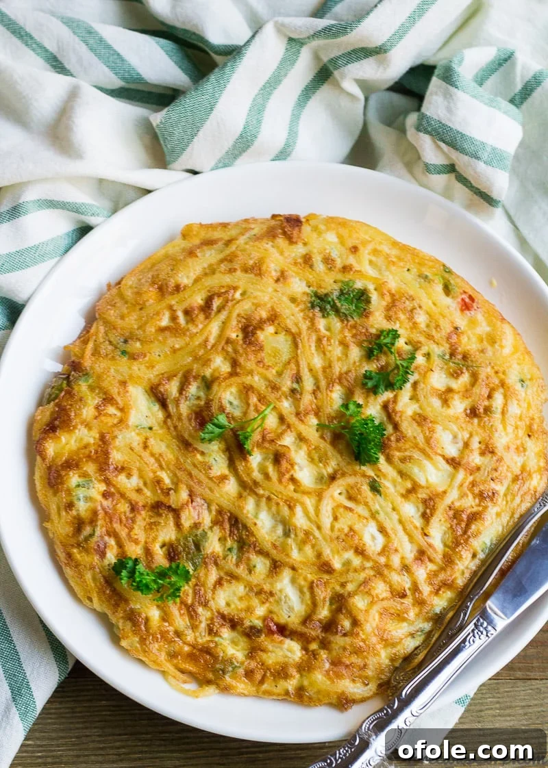 Golden Spaghetti Frittata 2 Spaghetti omelette on a plate, ready to be served for breakfast