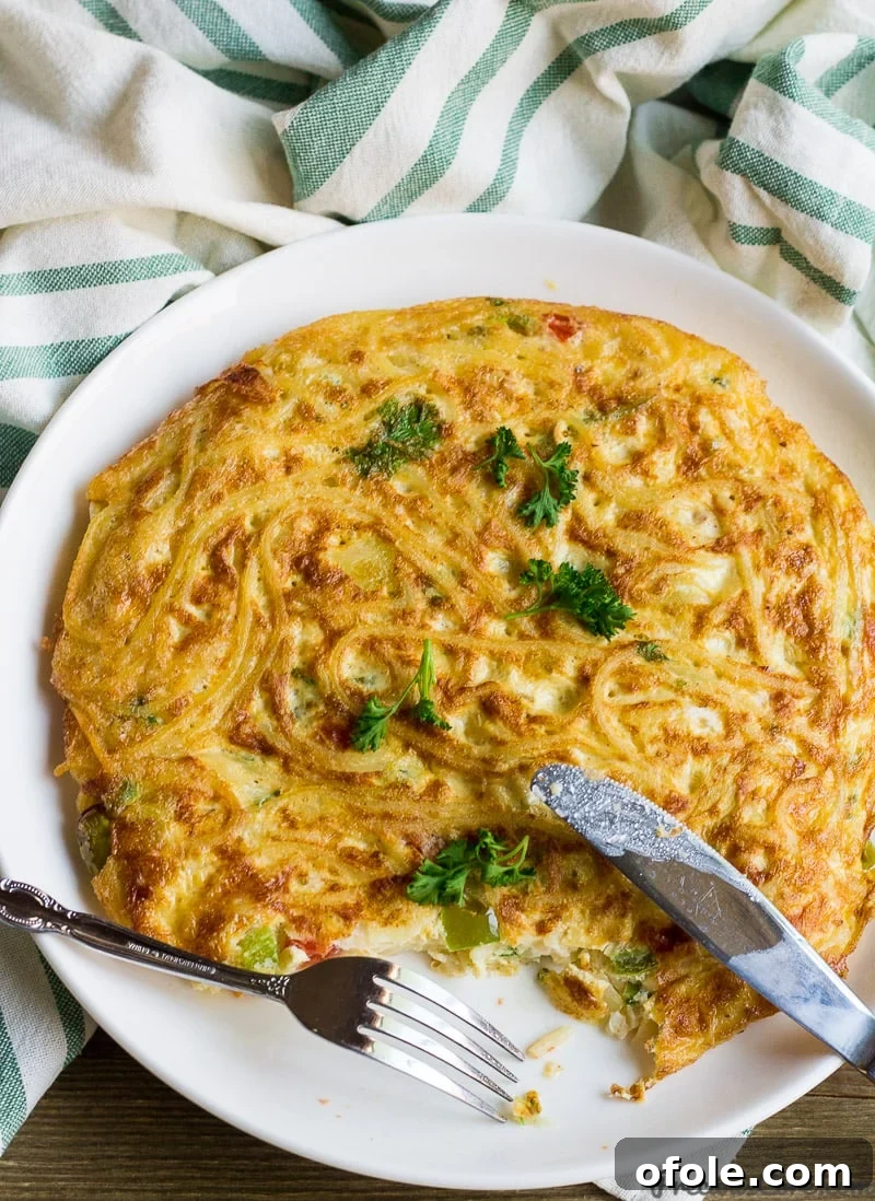 Close-up of a Spaghetti Omelette or Spaghetti Frittata, showcasing its texture and ingredients, ideal for a hearty breakfast or brunch.